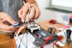 Man connecting the electronic parts on drone